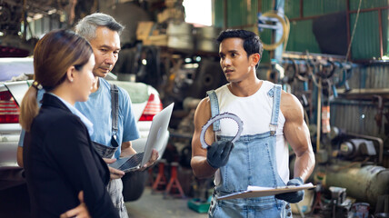 Asian young woman customer talking with owner and mechanic worker at car repair service and auto store shop.