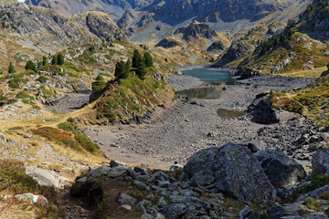 Landscape of almost dry mountain lake in Belledonne moutain range