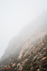 Morning mist fog haze on Morro rock California. USA travelling along the highway 101. Volcanic plug formation