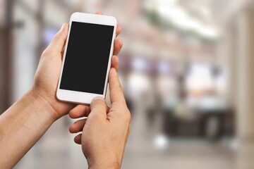 Human hand hold a phone with a blank screen