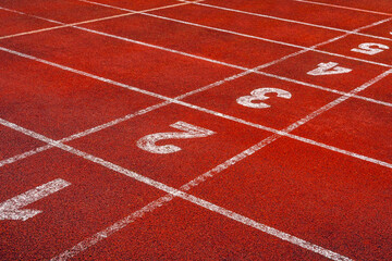 Fototapeta premium Start points with numbers on running track or athlete track in stadium