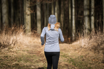 Fototapeta premium Woman running outdoors. Fitness jogging in fall forest. Sport activity