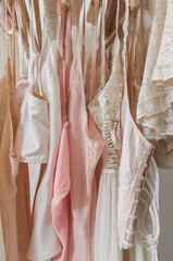 vintage pastel lingerie on hangers in a closet