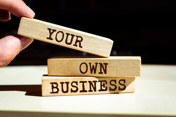 Wooden blocks with words 'Your Own Business'. Business concept