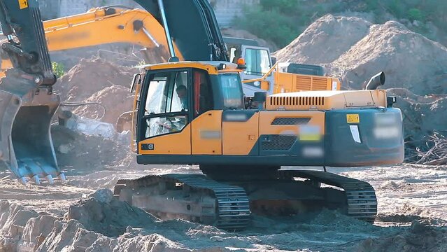 The excavator loading crushed stone into a dump truck in a crushed stone quarry
