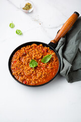Traditional italian bolognese sauce in saucepan cooking food