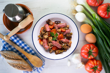 Iberian pork sausages sautéed with vegetables. Tapa typical center of Spain.