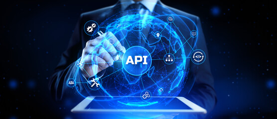 API Application programming interface. Businessman pressing virtual button.