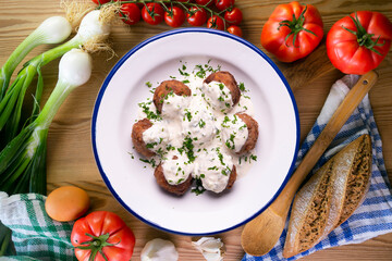 Pork meatballs with Greek tzatziki sauce with cucumber and yogurt. Traditional Greek recipe.