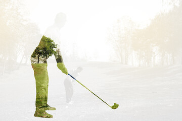 Double exposure of golf player holding club with golf course..