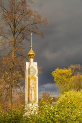 Fototapeta na wymiar Orthodox chapel on the background of an autumn cloudy sky