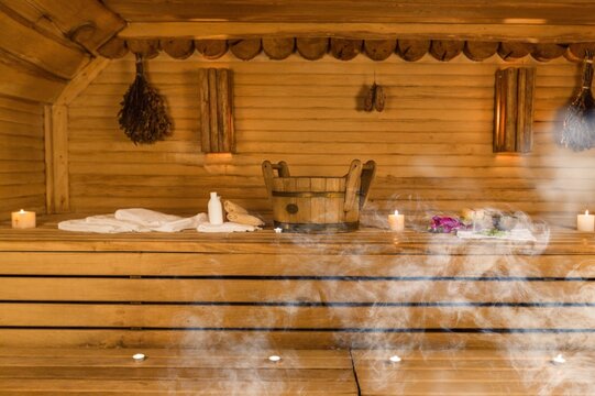 Interior of wooden sauna with hot white smoke steam.