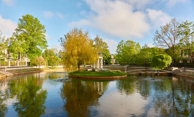 City park on a sunny day. Pond, stairway, promenade, gazebo. Liepaja, Latvia. Summer landscape. Public places, urban planning, landscaping design, gardening, recreation themes