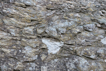 Close-up on the stone texture of mountain rock. Background.