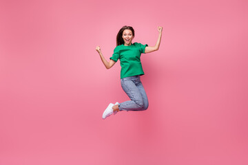 Full length photo of overjoyed energetic person jumping raise fists shout yes isolated on pink color background