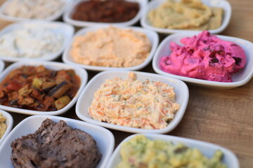 
​Meze or mezze is a selection of small dishes served as appetizers in much of West Asia, Middle East, and the Balkans. Meze is often served as a part of multi-course meals.