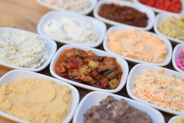 Meze or mezze is a selection of small dishes served as appetizers in much of West Asia, Middle East, and the Balkans. Meze is often served as a part of multi-course meals.