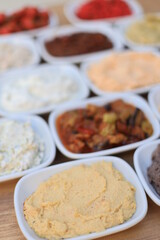
​Meze or mezze is a selection of small dishes served as appetizers in much of West Asia, Middle East, and the Balkans. Meze is often served as a part of multi-course meals.