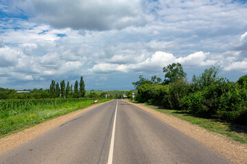 Fototapeta premium A country road stretching into the sky. 