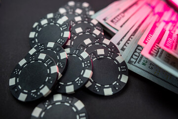 Poker chips and dollar bills on casino table. Gambling.