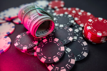 Poker chips and dollar bills on casino table. Gambling.