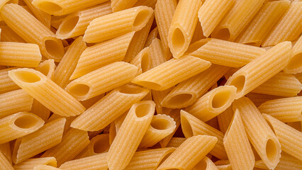 dish of raw pasta penne top view. penne pasta background. Carbo food,