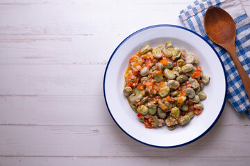 Beans with ham. Typical Spanish tapas recipe.