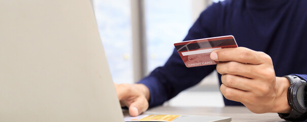 Businessman holding credit card for online shopping bill on smartphone, positive man shopping online remote payment , smart payment concept individual bank