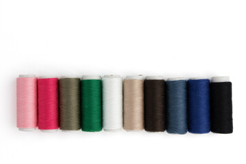 sewing colored threads isolated on white