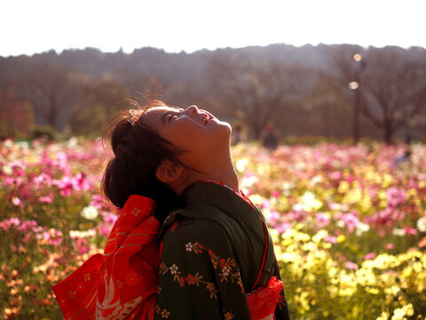 Girl Looks Up The Sky Front Of Cosmos Flower