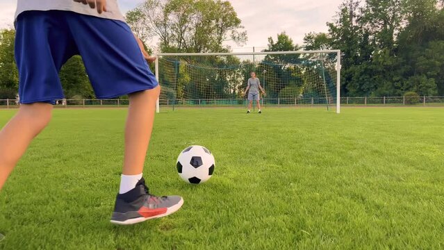 Sportsman is in control of ball. Boy with soccer ball. Boy juggles soccer ball. Child dream of football match. Sports training in park. Child juggles ball. Healthy lifestyle