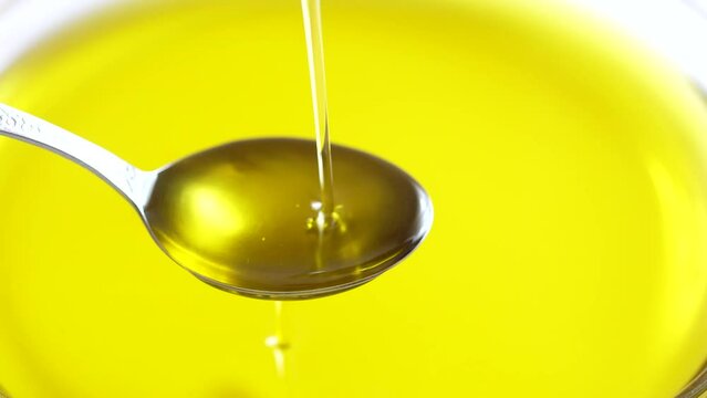 Pouring extra virgin olive oil on spoon