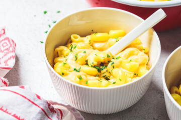 Mac and cheese in white bowl. Traditional American food.