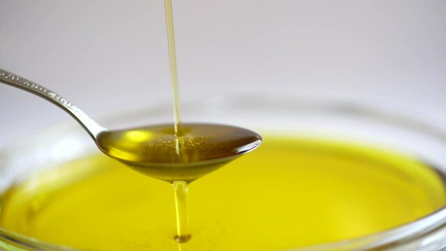 Pouring extra virgin olive oil on spoon