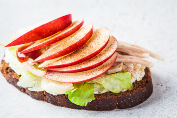 Turkey and apple sandwich, gray background. Thanksgiving leftovers concept.