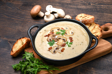Mushroom champignon soup with bread and fresh mushrooms. top view