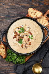 Mushroom champignon soup with bread and fresh mushrooms. top view