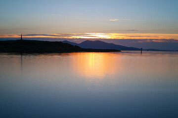 Fototapeta na wymiar Sunset over Oban Bay and the entrance to Oban harbour with the isle of Kerrera in the back