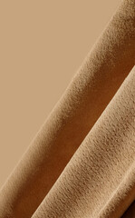 Suede leather waves diagonal close-up, texture of sand leather with copy space, vertical photo