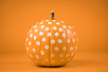 polka dots Orange pumpkin on orange background. haloween concept.