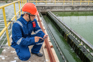 Water plant maintenance technicians, mechanical engineers check the control system at the water treatment plant.