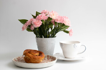 Obraz na płótnie Canvas Breakfast in the morning with Mini Carnation flowers in a white glass on white background