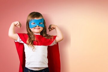 Emotional child superhero in flying gesture wears costume