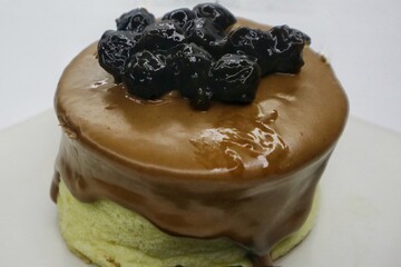 Japanese Souffle Pancake. A plate of fluffy pancake with Cappucino Boba topping isolated on white background. Close up