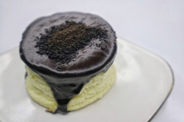 Japanese Souffle Pancake. A plate of fluffy pancake with Choco Oreo topping isolated on white background. Close up