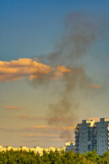 Black smoke rising from high-rise residential buildings.