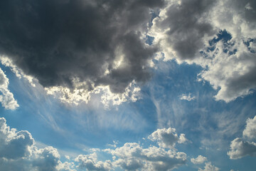 Background with high blue sky and white clouds. Summer sky with cumulus clouds.
