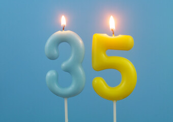 Birthday candles on blue background, number 35