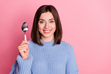 Closeup photo of young hungry woman showing metal spoon want eat tasty food now isolated on pink color background