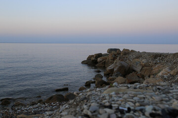 sea coast with breakwater rocks at dawn
